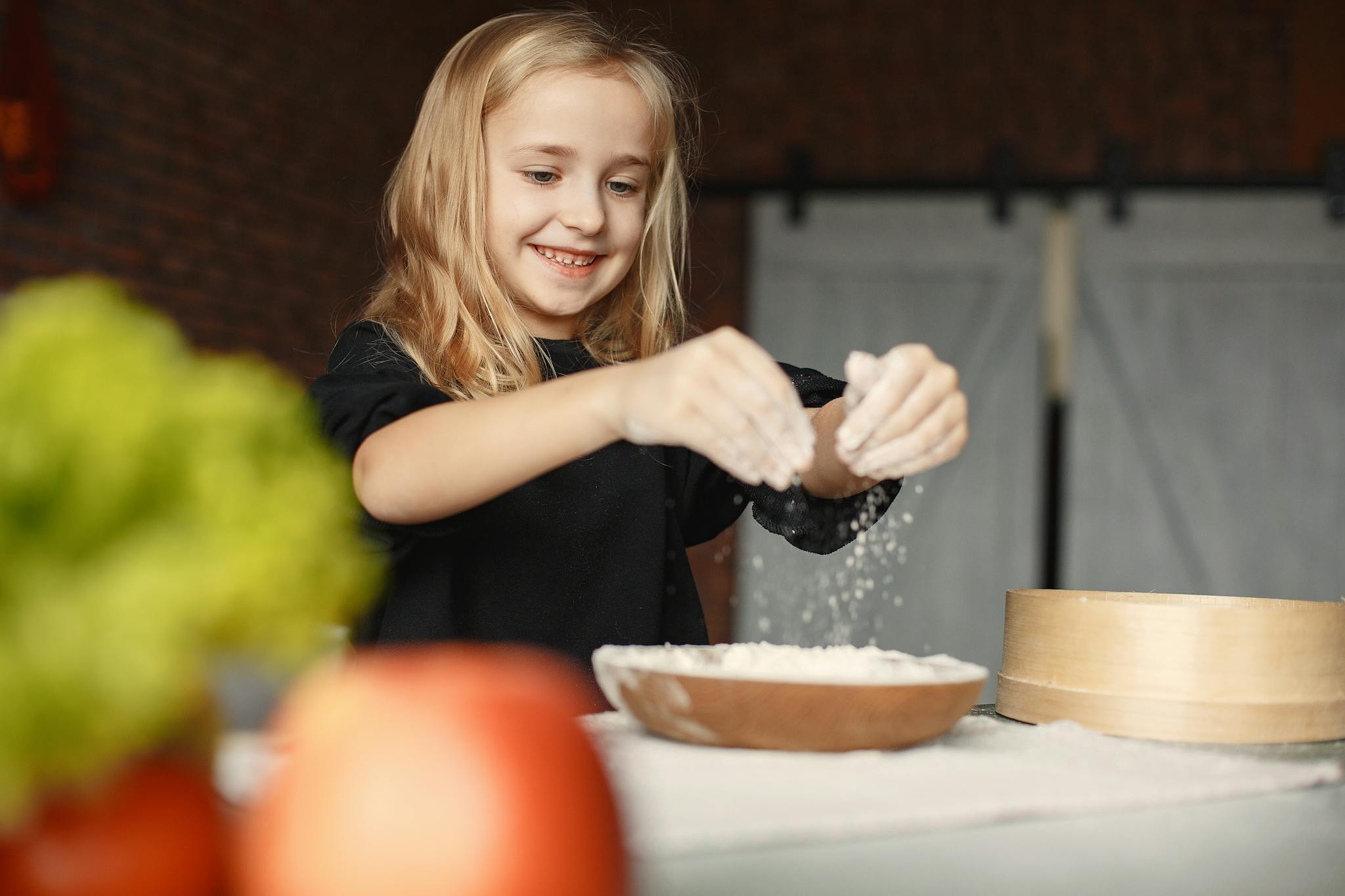 Cheerful girl enjoying baking in a cozy kitchen setting.