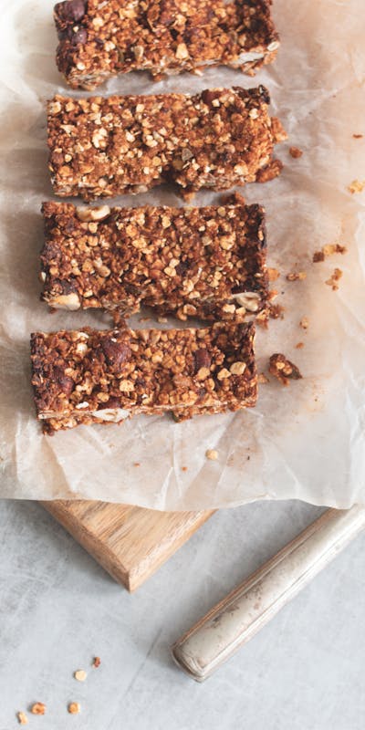 Delicious homemade granola bars on a wooden board, perfect for healthy snacking and meal preparation.